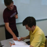 Thomas and Randall discussing one of the programming problems.