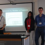 Thomas, Maya, and Randall presenting their research.